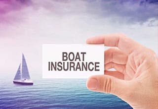 sailboat in the ocean and boat insurance card